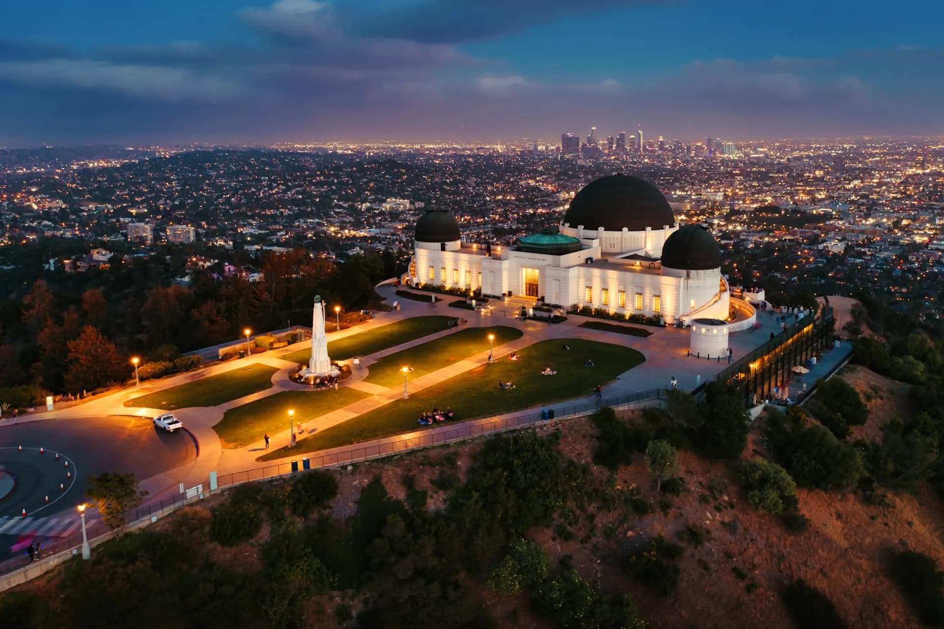Aerial night view of the illuminated Griffith Observatory dome and grounds, overlooking the glowing city lights of the sprawling Los Angeles basin, illustrating the surrounding region served by our local Skilled Nursing Facilities.
